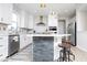 Updated kitchen with white cabinetry, stainless steel appliances, an island with seating, and designer lighting at 5300 Veranda Dr, Noblesville, IN 46062
