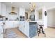 Modern kitchen island featuring a stone base, pendant lighting, white cabinets, and stainless appliances at 5300 Veranda Dr, Noblesville, IN 46062