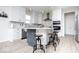 Bright kitchen with white cabinets, island with seating, stainless appliances, and modern backsplash at 5300 Veranda Dr, Noblesville, IN 46062