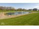 Beautiful pond with a fountain, surrounded by green lawns at 5300 Veranda Dr, Noblesville, IN 46062