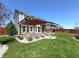 Spacious backyard with a patio, pergola, and beautifully landscaped yard at 5493 W Woodhaven Dr, McCordsville, IN 46055