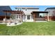 Spacious backyard showcasing outdoor kitchen, patio and pergola at 5493 W Woodhaven Dr, McCordsville, IN 46055