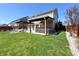 Large backyard featuring a patio, pergola, built-in outdoor kitchen, and lush green grass at 5493 W Woodhaven Dr, McCordsville, IN 46055