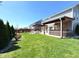 Spacious backyard with a patio, outdoor kitchen, pergola and manicured lawn at 5493 W Woodhaven Dr, McCordsville, IN 46055