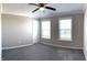 Bedroom featuring soft carpet, a ceiling fan, two windows, and neutral paint color at 5493 W Woodhaven Dr, McCordsville, IN 46055
