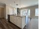 Bright eat-in kitchen featuring gray countertops and a stylish central island with bar seating at 5493 W Woodhaven Dr, McCordsville, IN 46055