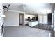 Open-concept living space with view into the kitchen, featuring a granite island and stainless steel appliances at 5493 W Woodhaven Dr, McCordsville, IN 46055