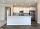 Bright kitchen featuring white cabinetry, stainless steel appliances, granite countertops, and modern lighting fixtures at 5493 W Woodhaven Dr, McCordsville, IN 46055