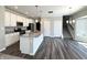 Open-concept kitchen featuring a kitchen island, stainless appliances, and a tiled backsplash at 5493 W Woodhaven Dr, McCordsville, IN 46055