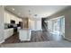 Modern kitchen with stainless steel appliances, granite countertops, and a view into the living area at 5493 W Woodhaven Dr, McCordsville, IN 46055