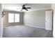 Spacious main bedroom with neutral carpeting, a ceiling fan, and a window with blinds at 5493 W Woodhaven Dr, McCordsville, IN 46055