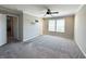 Spacious main bedroom with neutral carpeting, ceiling fan, large window and an ensuite bath at 5493 W Woodhaven Dr, McCordsville, IN 46055