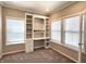 Bright office space featuring built-in shelving and desk, carpeted floors, and natural light from two windows at 5493 W Woodhaven Dr, McCordsville, IN 46055