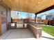 Outdoor kitchen featuring a built-in grill, and a bar area under a covered patio at 5493 W Woodhaven Dr, McCordsville, IN 46055