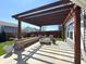 Beautiful patio with pergola, brick fire pit and outdoor seating area at 5493 W Woodhaven Dr, McCordsville, IN 46055