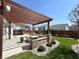 Spacious outdoor patio featuring a built-in grill and a charming pergola at 5493 W Woodhaven Dr, McCordsville, IN 46055