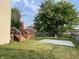 Private backyard featuring a large deck, mature trees, grassy lawn, and a basketball court at 5663 Rains Ln, Indianapolis, IN 46254