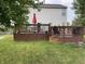 Spacious two-tier wood deck with ample seating area and an umbrella, perfect for outdoor entertaining at 5663 Rains Ln, Indianapolis, IN 46254