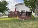 Spacious two-tier wood deck with ample seating area and an umbrella, perfect for outdoor entertaining at 5663 Rains Ln, Indianapolis, IN 46254