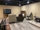 Spacious basement features dark ceiling, rec space, fire place and potential for media space at 5663 Rains Ln, Indianapolis, IN 46254