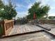 Spacious wooden deck with outdoor seating, red umbrella, and a view of the backyard and neighboring houses at 5663 Rains Ln, Indianapolis, IN 46254