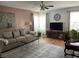 Inviting living room with soft colors, comfortable seating, lots of plants, and bright natural light at 5663 Rains Ln, Indianapolis, IN 46254