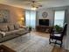 Inviting living room with soft colors, comfortable seating, lots of plants, and bright natural light at 5663 Rains Ln, Indianapolis, IN 46254