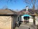View of a backyard deck featuring a grill, dining table, and seating beneath a turquoise umbrella at 5739 E 62Nd Pl, Indianapolis, IN 46220
