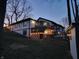 Backyard view of home with deck, string lights, and shed at dusk at 5739 E 62Nd Pl, Indianapolis, IN 46220