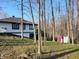 Exterior shot of a house with a small storage shed and a partially wooded backyard at 5739 E 62Nd Pl, Indianapolis, IN 46220