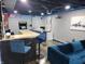 Finished basement featuring a bar, seating area, arcade game, and basketball hoop for recreation at 5739 E 62Nd Pl, Indianapolis, IN 46220