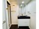 Contemporary bathroom showcasing a shower, modern vanity, black countertop, and sleek, minimalist design at 5739 E 62Nd Pl, Indianapolis, IN 46220