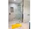 Modern bathroom featuring a glass-enclosed shower, marble tile, and a niche for toiletries at 5739 E 62Nd Pl, Indianapolis, IN 46220