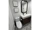Modern bathroom with a stylish vanity, marbled tile floor, and elegant decor at 5739 E 62Nd Pl, Indianapolis, IN 46220
