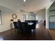 Open dining room featuring a modern chandelier, large table, and backyard views at 5739 E 62Nd Pl, Indianapolis, IN 46220