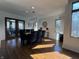 Bright dining room with modern chandelier, large dining table, and access to the backyard at 5739 E 62Nd Pl, Indianapolis, IN 46220