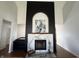 Stylish fireplace with marble surround and a unique black arched accent wall at 5739 E 62Nd Pl, Indianapolis, IN 46220