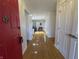 Inviting foyer with hardwood floors, a bright red door, and neutral paint at 5739 E 62Nd Pl, Indianapolis, IN 46220