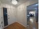 Foyer with a modern chandelier and views into the kitchen and dining area at 5739 E 62Nd Pl, Indianapolis, IN 46220