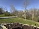 Landscaped front yard with a mix of green grass, trees, and some mulch with flower beds at 5739 E 62Nd Pl, Indianapolis, IN 46220