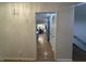 Hallway with access to the kitchen and dining area, featuring hardwood floors at 5739 E 62Nd Pl, Indianapolis, IN 46220