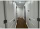 Hallway with white doors leading to various rooms, offering privacy and functionality at 5739 E 62Nd Pl, Indianapolis, IN 46220