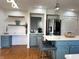 Modern kitchen featuring stainless steel appliances, a center island, and stylish blue-gray cabinetry at 5739 E 62Nd Pl, Indianapolis, IN 46220