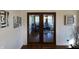 View of a living room through French doors with decorative mirrors on the adjacent walls at 5739 E 62Nd Pl, Indianapolis, IN 46220