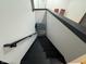 Modern black staircase with a white wall and handrail leading to the lower level at 5739 E 62Nd Pl, Indianapolis, IN 46220