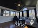 Sunroom with many windows, black ceiling, hardwood floors, and seating at 5739 E 62Nd Pl, Indianapolis, IN 46220