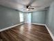 Bedroom with laminate floors, blue paint, white trim and door, and a ceiling fan at 601 Duane St, Franklin, IN 46131