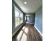 Hallway and entryway showing off new laminate floors, many windows, and fresh blue paint at 601 Duane St, Franklin, IN 46131