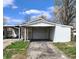 Single car garage with paved driveway on a sunny day surrounded by new spring growth at 601 Duane St, Franklin, IN 46131