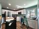 Bright kitchen with white cabinets, granite countertops, stainless steel appliances, and laminate floors at 601 Duane St, Franklin, IN 46131